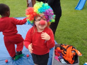 Child wearing a red nose celebrating Red Nose Day at Milton Keynes Preparatory School